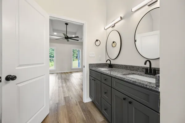 a bathroom with a granite countertop sink mirror and vanity
