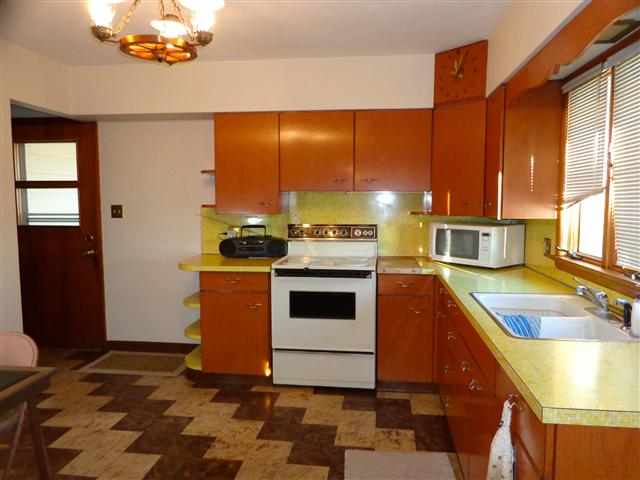 1076 West Becker School Road Freeport, IL 61032 - Photo 5 of 12 a kitchen with a stove a sink and a microwave