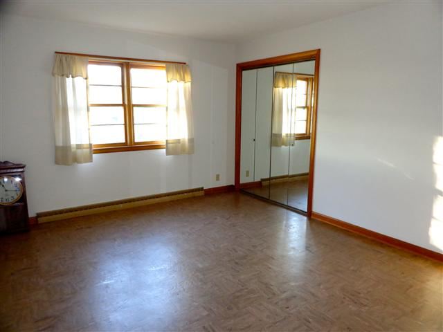 1076 West Becker School Road Freeport, IL 61032 - Photo 6 of 12 an empty room with wooden floor and windows
