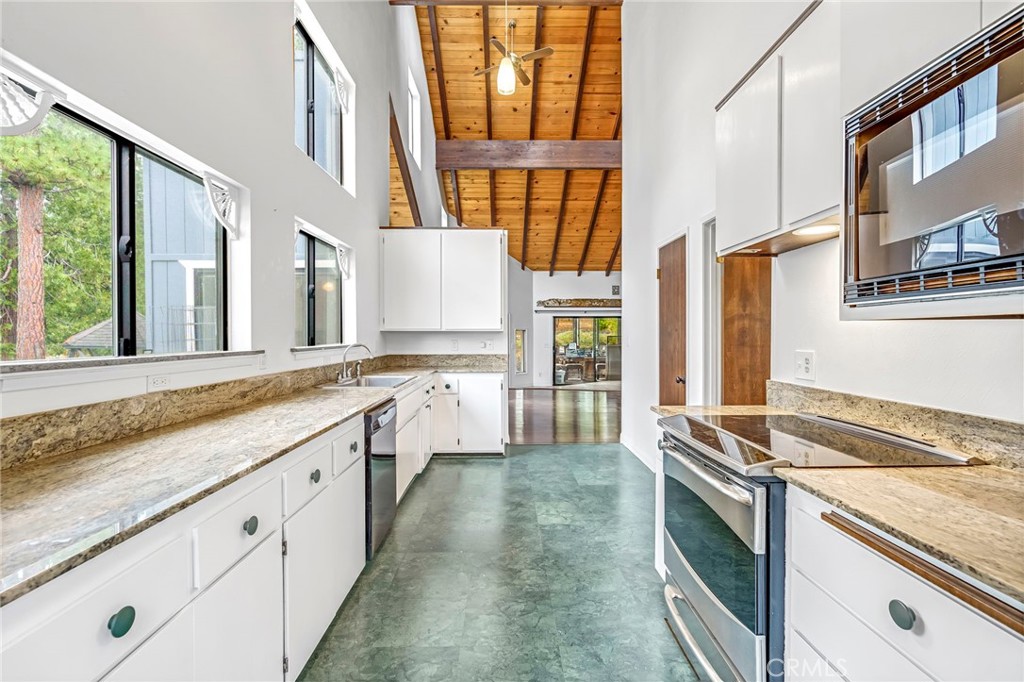 37068 Mudge Ranch Road Coarsegold, CA 93614 - Photo 14 of 53 a kitchen with granite countertop a stove and a sink