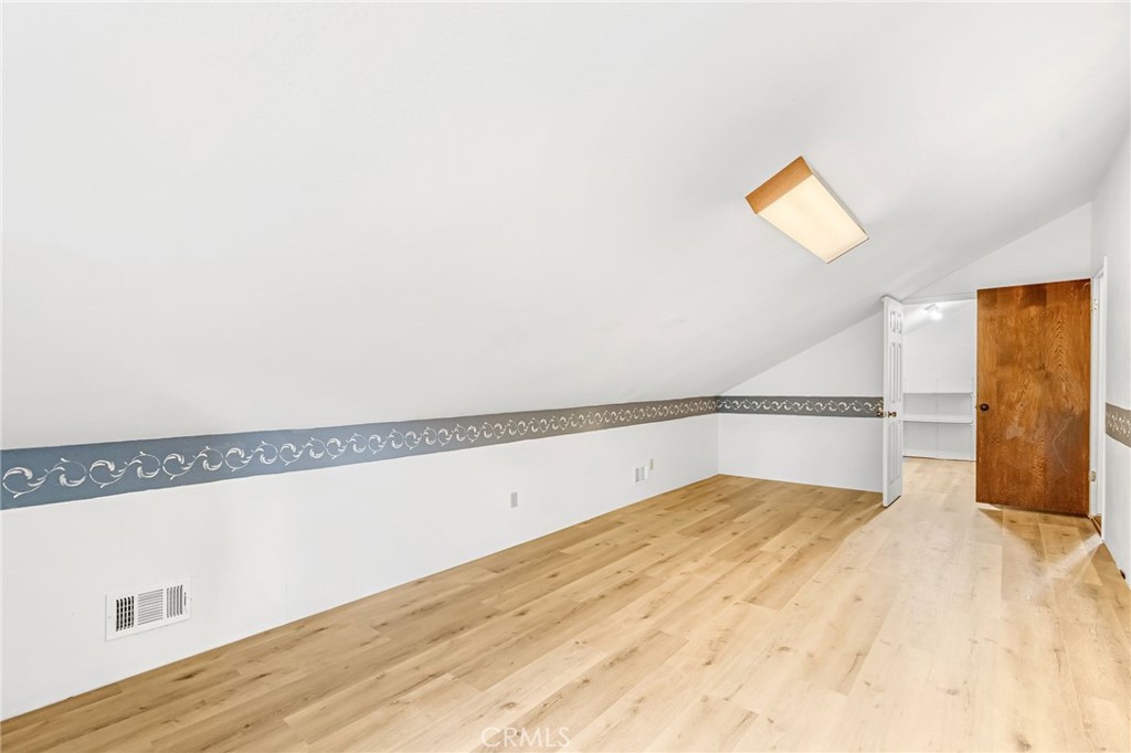 37068 Mudge Ranch Road Coarsegold, CA 93614 - Photo 29 of 53 a view of a room with wooden floor and a ceiling fan