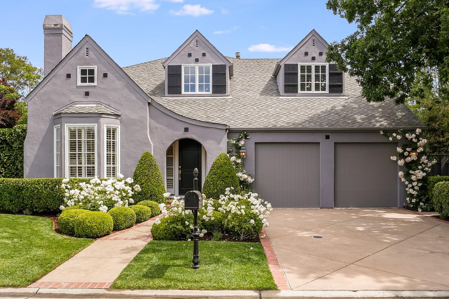 75 Riordan Place Menlo Park, CA 94025 - Photo 1 of 55 a front view of a house with a yard and potted plants