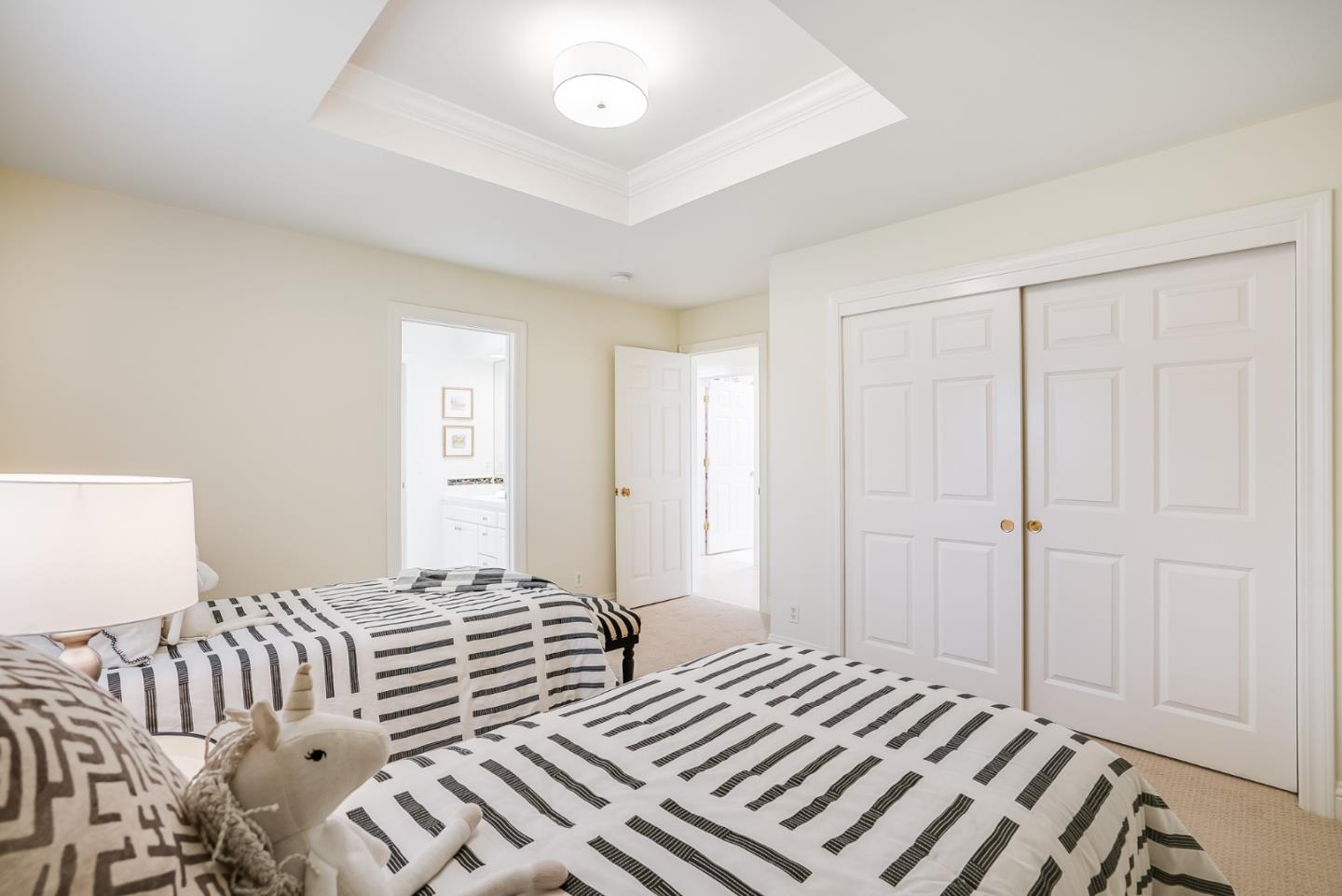 75 Riordan Place Menlo Park, CA 94025 - Photo 26 of 55 a bedroom with a bed and a chandelier