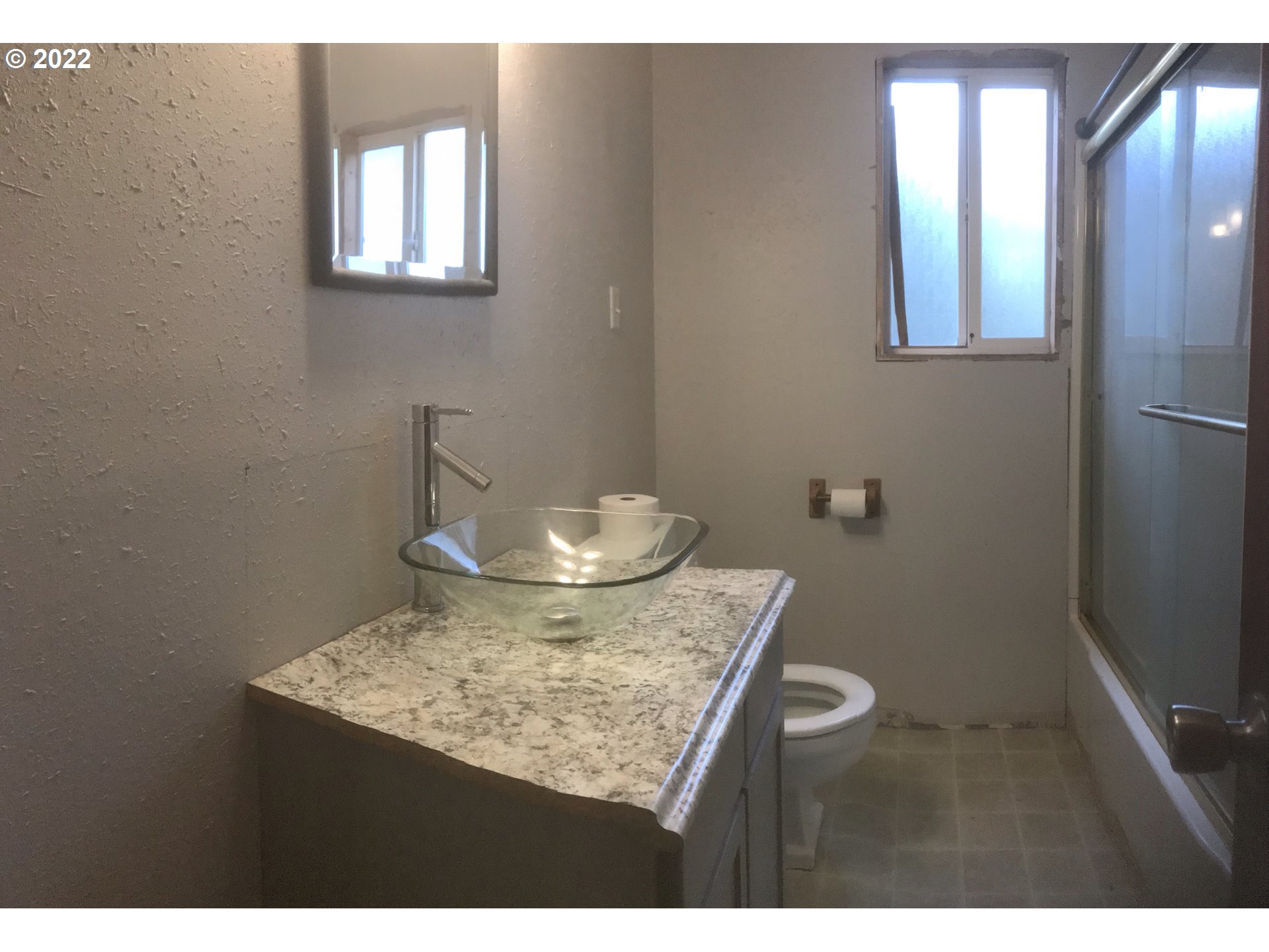 1470 Waite Street Eugene, OR 97402 - Photo 14 of 20 a view of a bathroom with a sink and a mirror