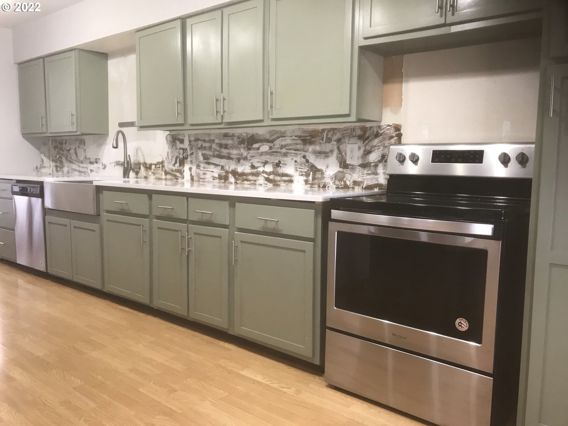 1470 Waite Street Eugene, OR 97402 - Photo 4 of 20 a kitchen with granite countertop white cabinets and white appliances