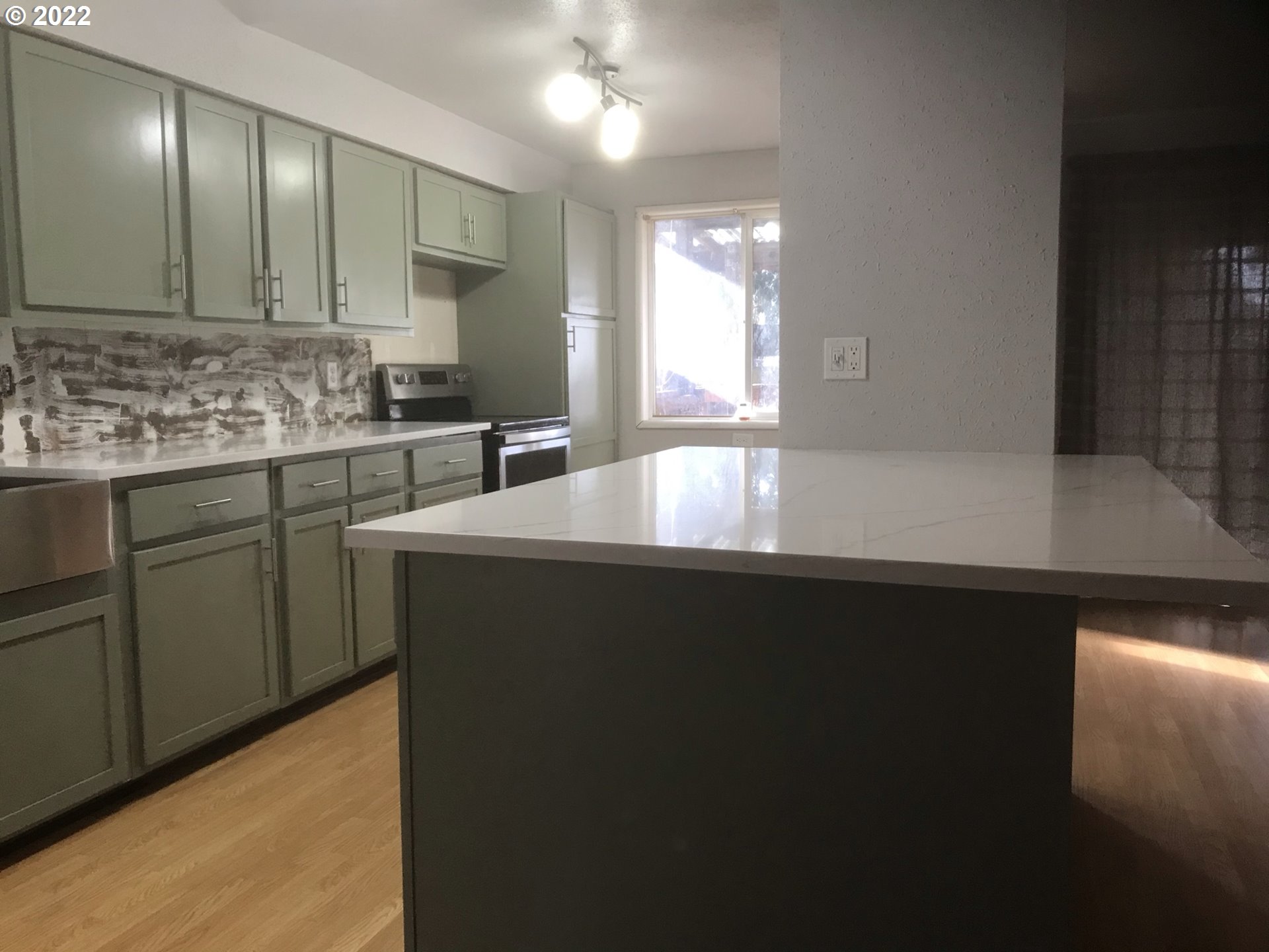 1470 Waite Street Eugene, OR 97402 - Photo 5 of 20 a kitchen with kitchen island a sink appliances and cabinets