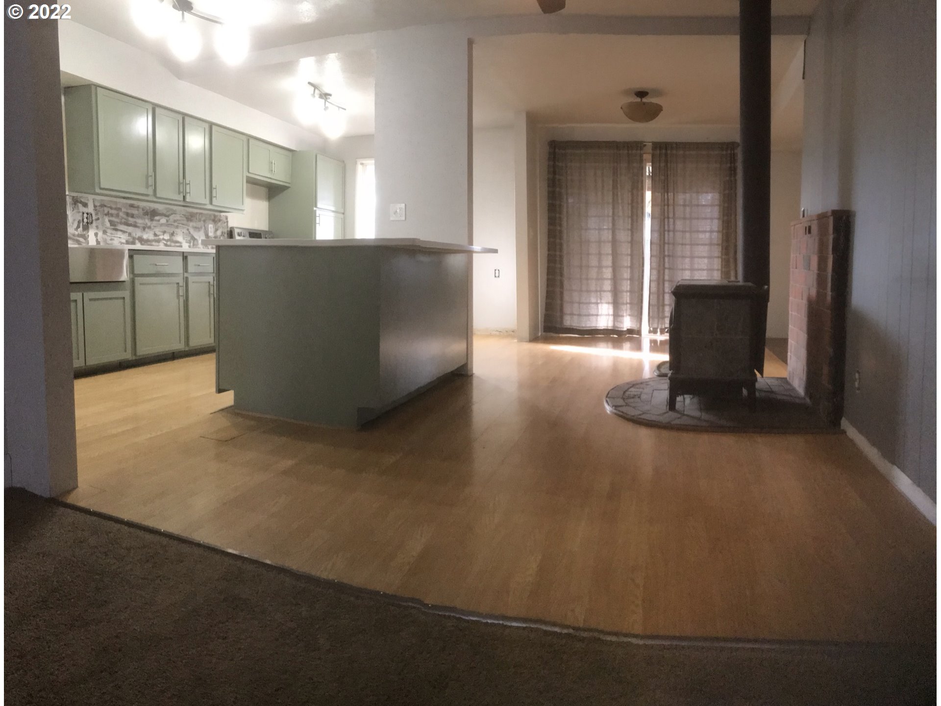 1470 Waite Street Eugene, OR 97402 - Photo 6 of 20 a view of a big room with wooden floor and windows