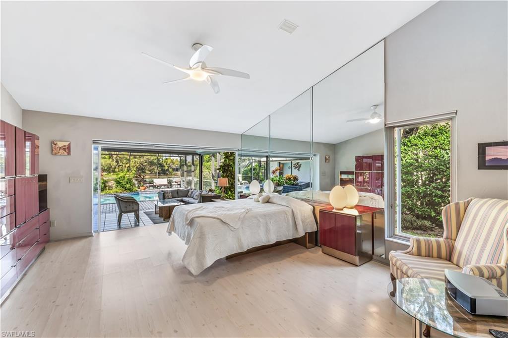 550 Bald Eagle Drive Naples, FL 34105 - Photo 15 of 37 a bed room with furniture and a large window