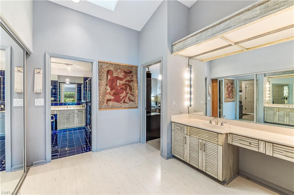 550 Bald Eagle Drive Naples, FL 34105 - Photo 17 of 37 a bathroom with a sink a mirror and a shower