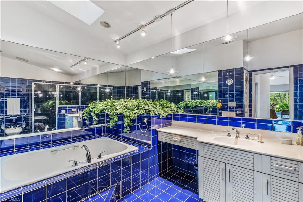 550 Bald Eagle Drive Naples, FL 34105 - Photo 18 of 37 a bathroom with a large tub and sink