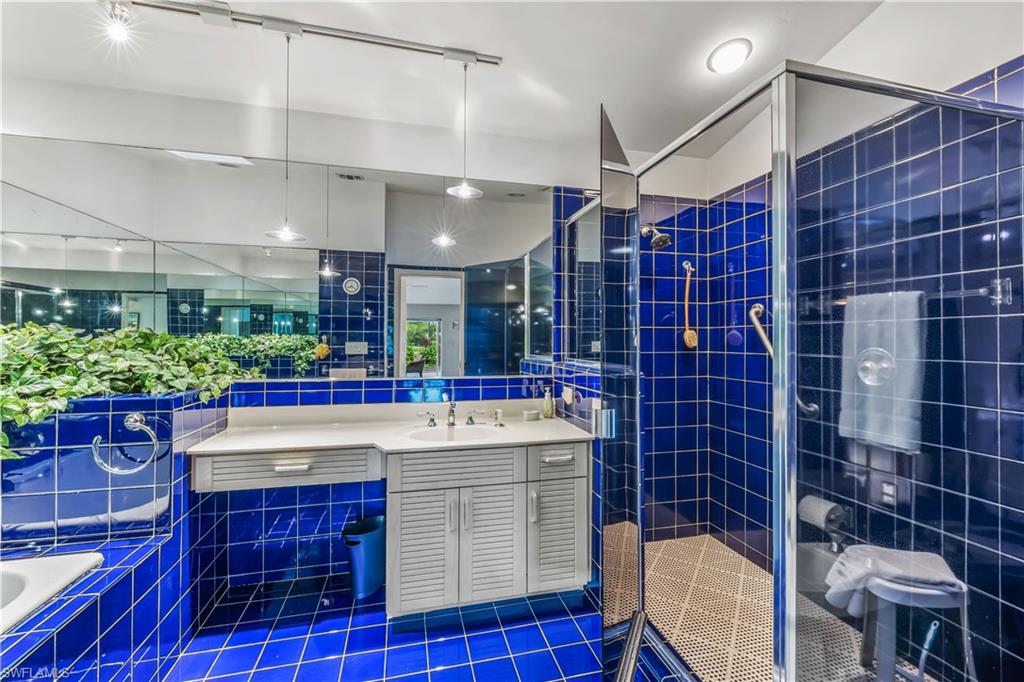 550 Bald Eagle Drive Naples, FL 34105 - Photo 19 of 37 a bathroom with a sink and a mirror