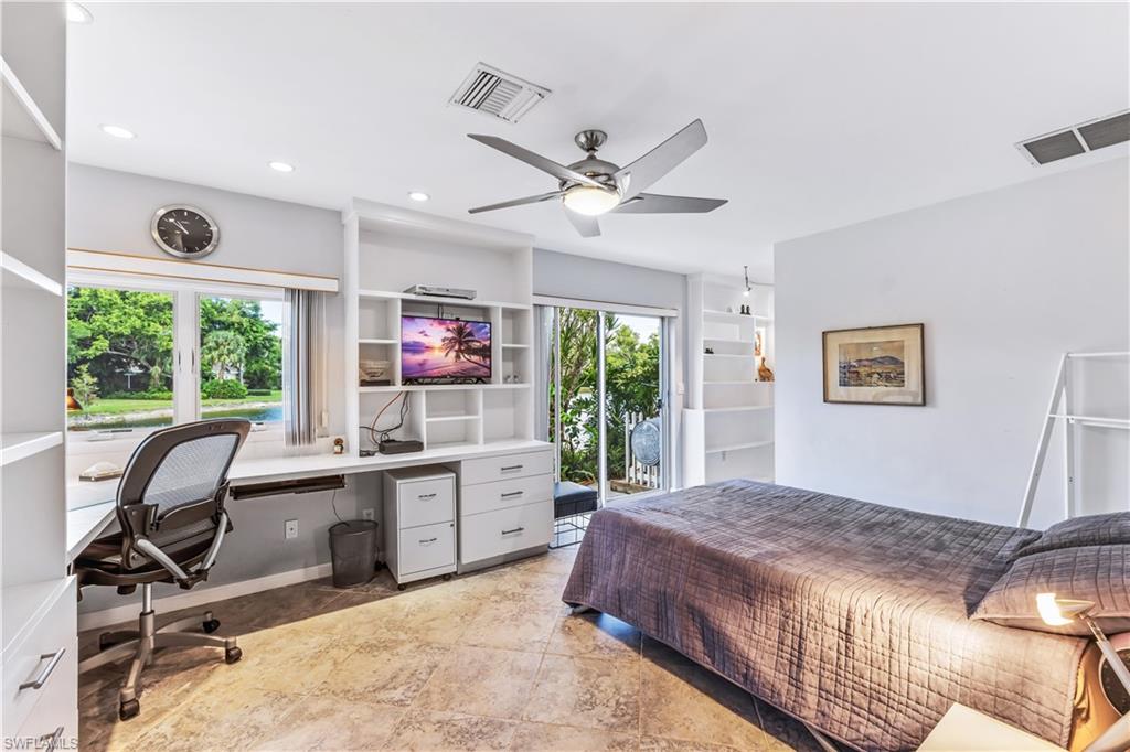 550 Bald Eagle Drive Naples, FL 34105 - Photo 22 of 37 a bed room with a bed and a desk