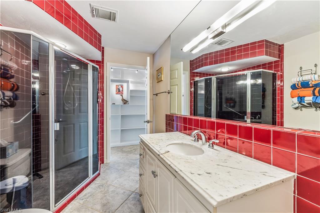 550 Bald Eagle Drive Naples, FL 34105 - Photo 24 of 37 a bathroom with a sink and shower