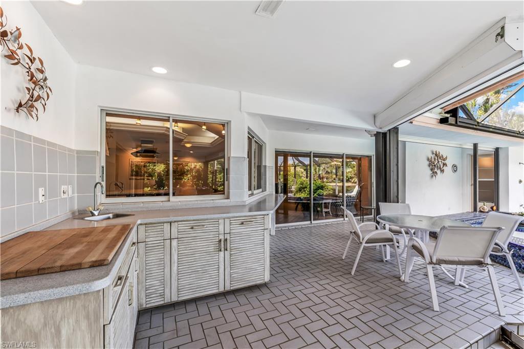 550 Bald Eagle Drive Naples, FL 34105 - Photo 27 of 37 a large living room with a large window