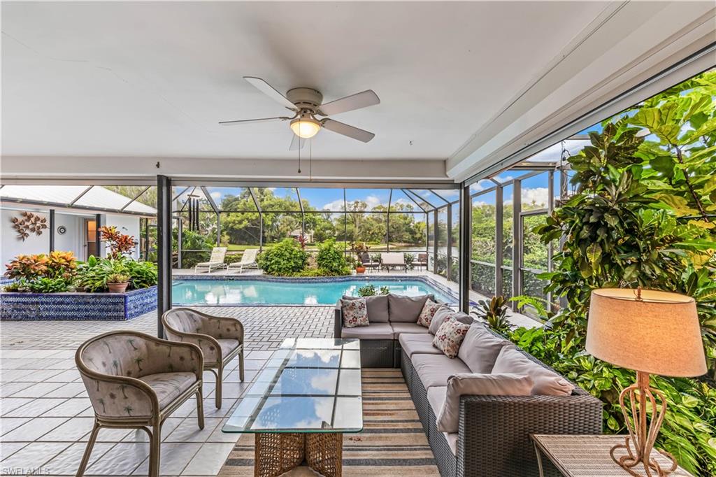 550 Bald Eagle Drive Naples, FL 34105 - Photo 28 of 37 a living room with patio furniture and a large window
