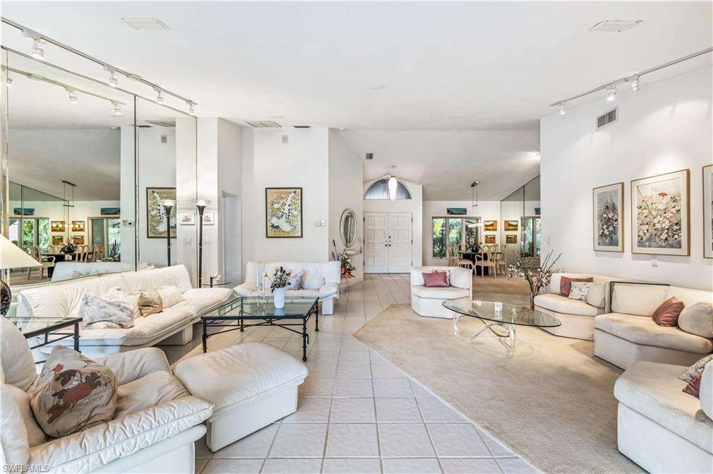 550 Bald Eagle Drive Naples, FL 34105 - Photo 3 of 37 a living room with furniture and a large window