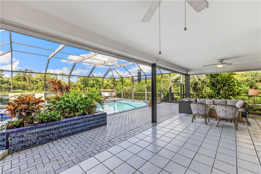 550 Bald Eagle Drive Naples, FL 34105 - Photo 31 of 37 a view of a patio with a table and chairs under an umbrella