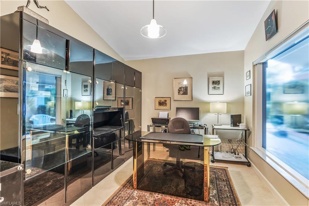 550 Bald Eagle Drive Naples, FL 34105 - Photo 7 of 37 a living room with furniture a large window and chairs