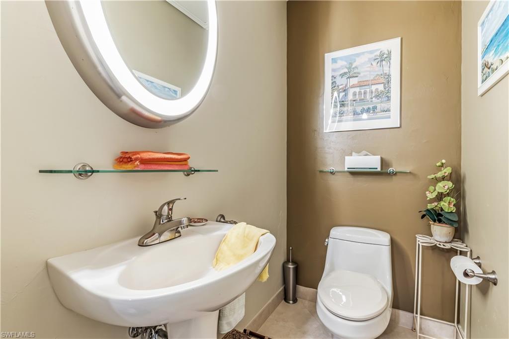 550 Bald Eagle Drive Naples, FL 34105 - Photo 8 of 37 a bathroom with a sink a toilet and a mirror