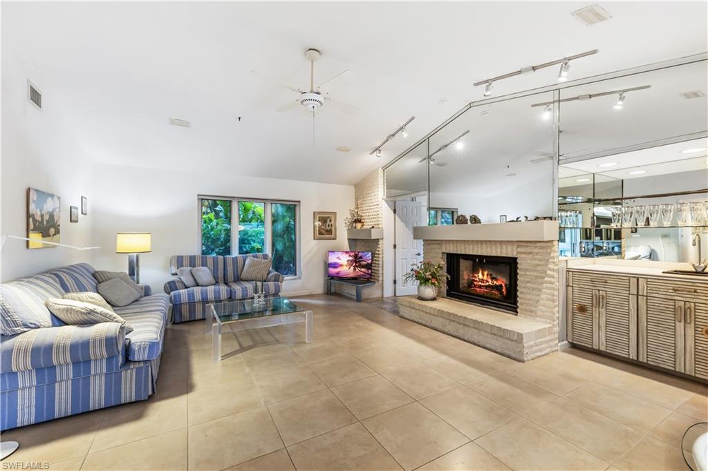550 Bald Eagle Drive Naples, FL 34105 - Photo 9 of 37 a living room with furniture and a fireplace