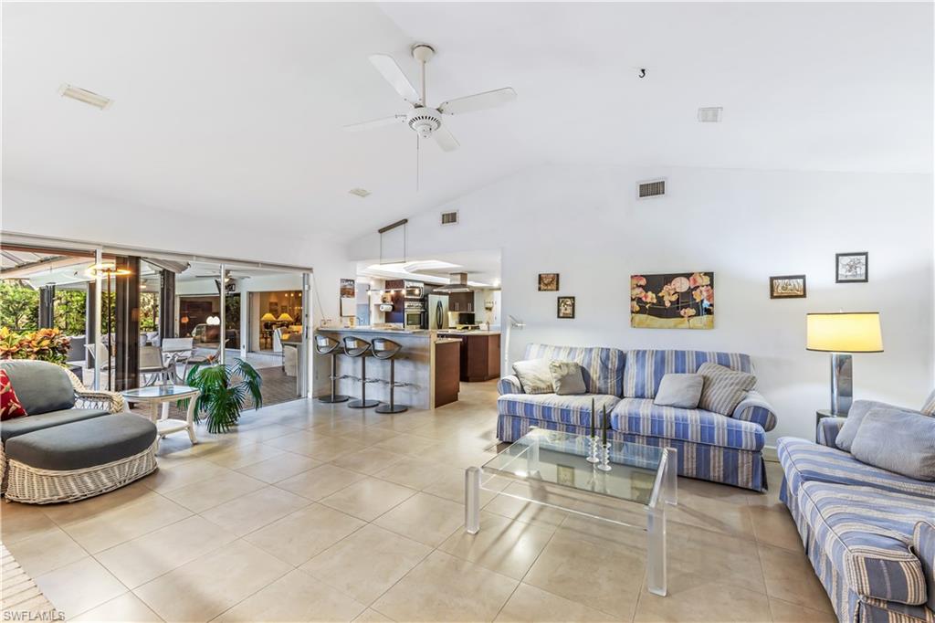 550 Bald Eagle Drive Naples, FL 34105 - Photo 10 of 37 a living room with furniture and a large window