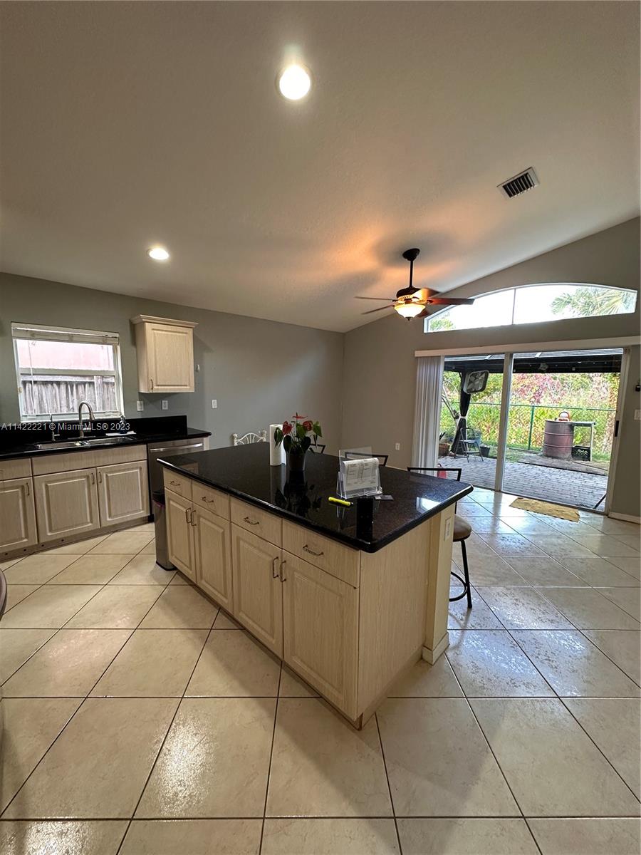 1041 Southeast 20th Road Homestead, FL 33035 - Photo 16 of 40 a kitchen with stainless steel appliances granite countertop a sink and a counter