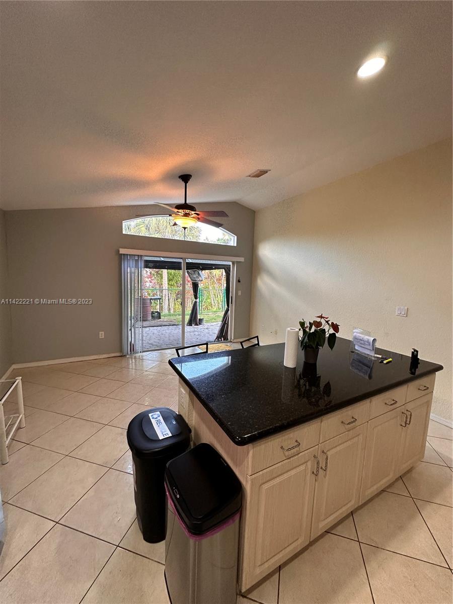 1041 Southeast 20th Road Homestead, FL 33035 - Photo 17 of 40 a kitchen with granite countertop a sink and a stove