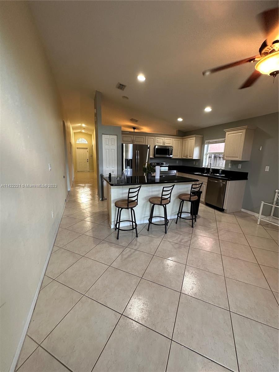 1041 Southeast 20th Road Homestead, FL 33035 - Photo 18 of 40 a view of a chairs and tables in a room