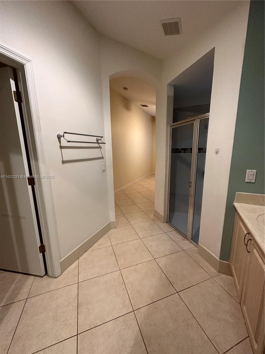 1041 Southeast 20th Road Homestead, FL 33035 - Photo 22 of 40 a view of hallway with stairs and a refrigerator