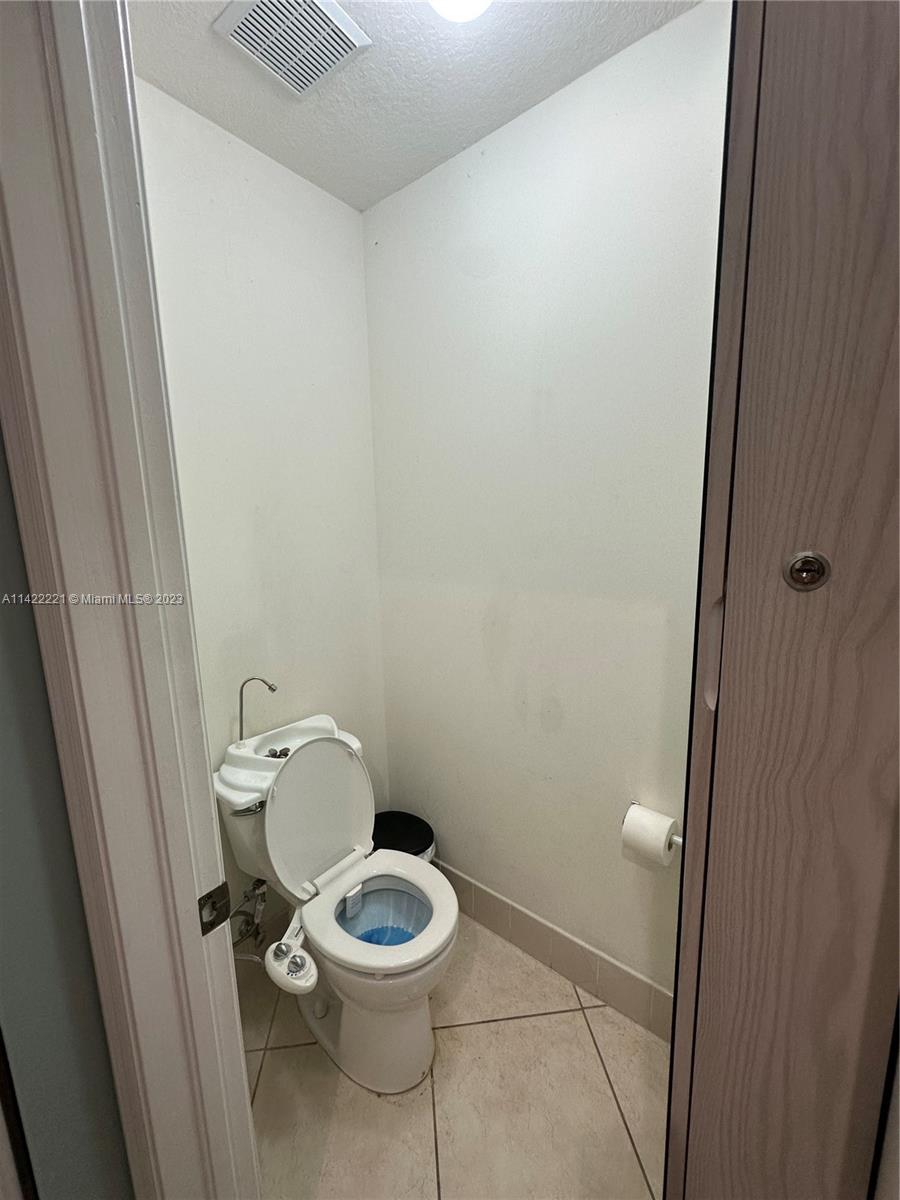 1041 Southeast 20th Road Homestead, FL 33035 - Photo 26 of 40 a white toilet sitting next to a sink