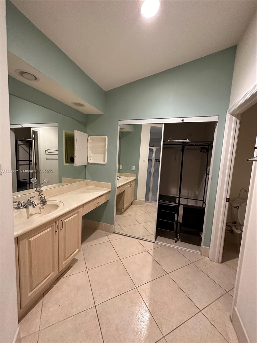 1041 Southeast 20th Road Homestead, FL 33035 - Photo 29 of 40 a bathroom with a sink and mirror