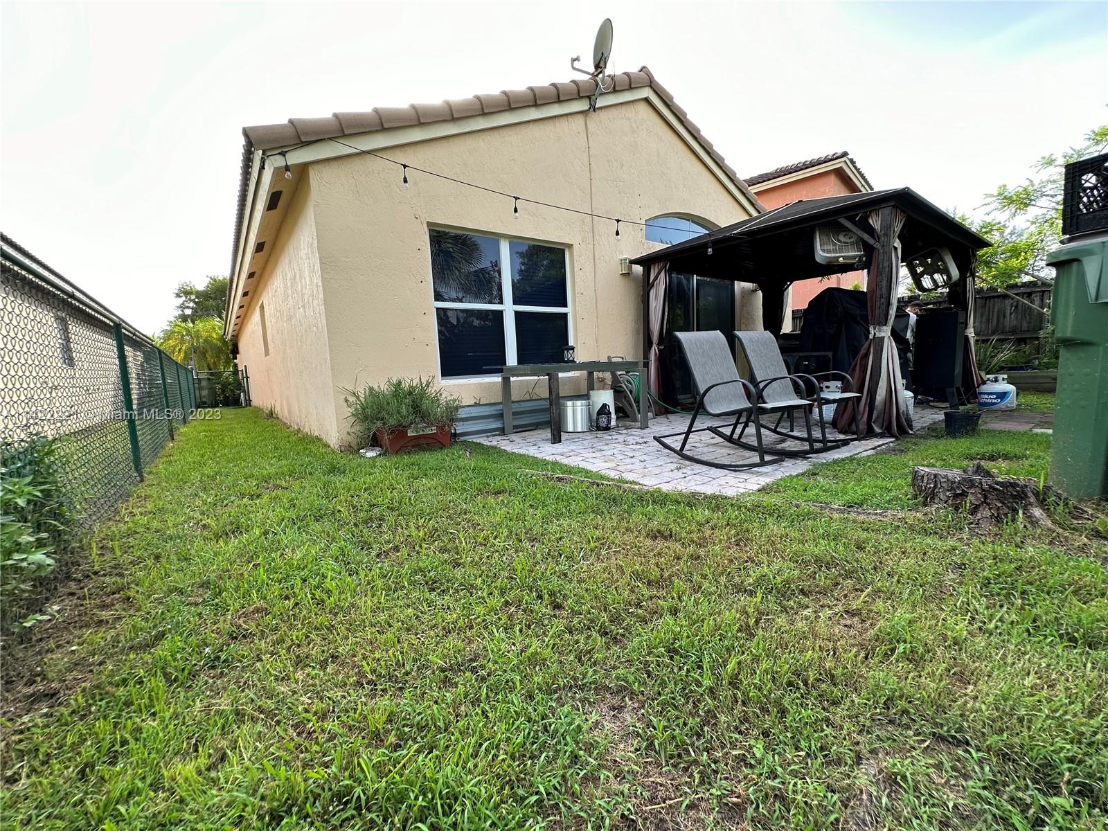 1041 Southeast 20th Road Homestead, FL 33035 - Photo 31 of 40 a view of a house with backyard and porch