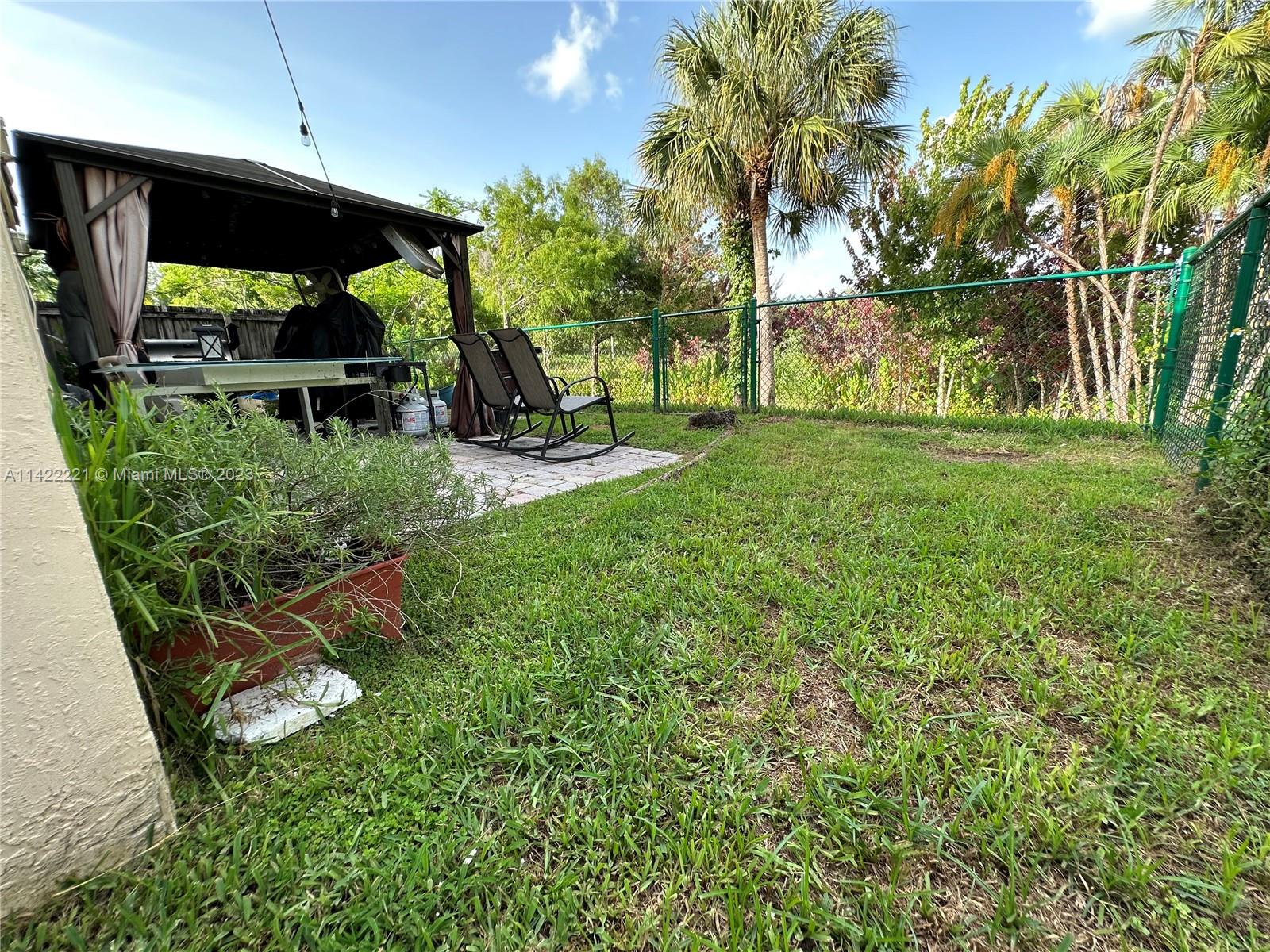 1041 Southeast 20th Road Homestead, FL 33035 - Photo 32 of 40 a view of a backyard with plants