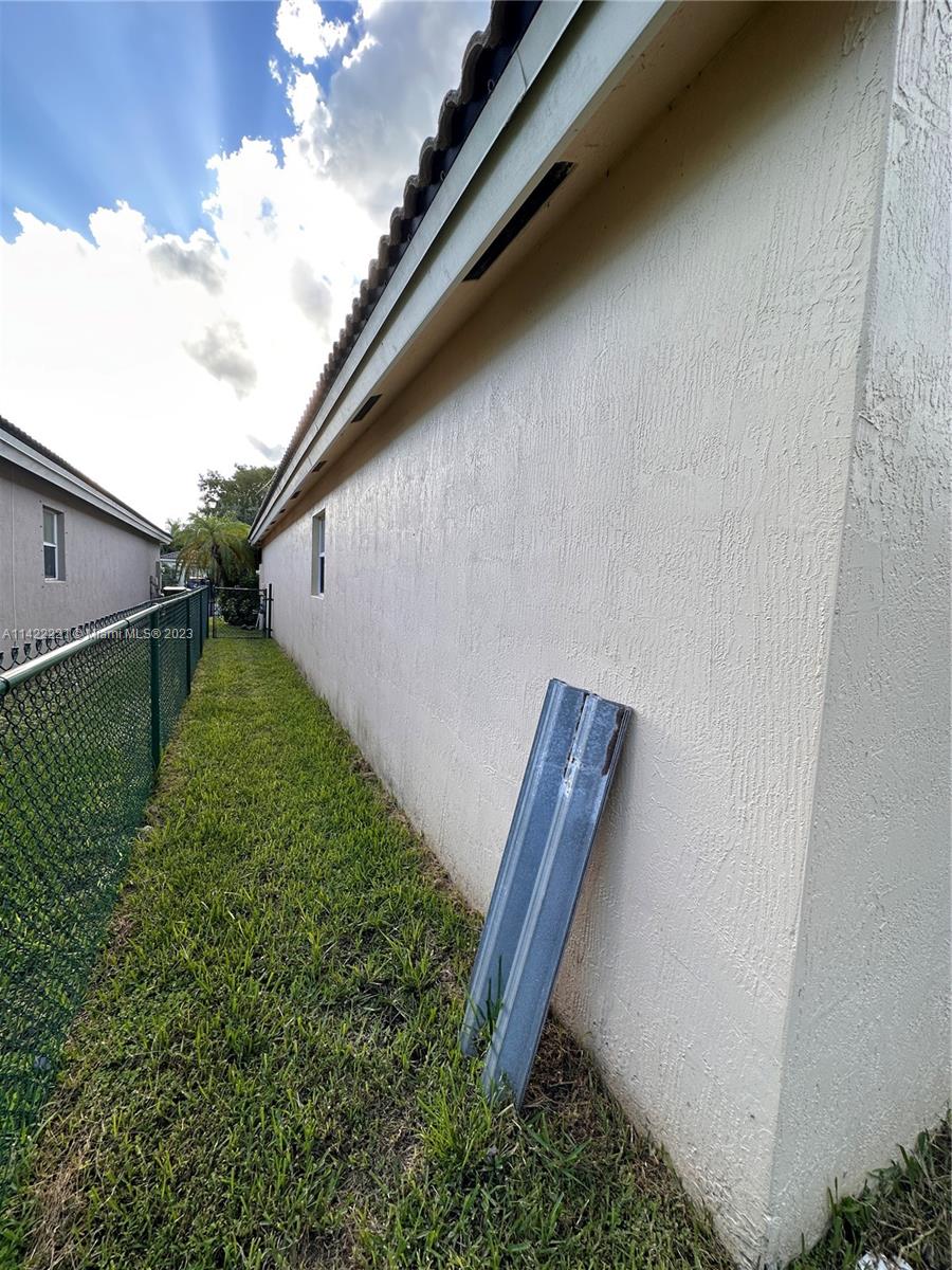 1041 Southeast 20th Road Homestead, FL 33035 - Photo 34 of 40 a backyard of a house with lots of green space