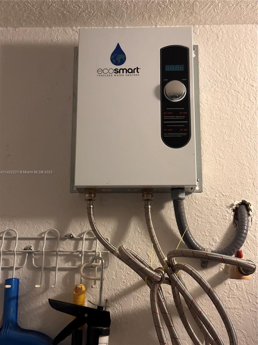 1041 Southeast 20th Road Homestead, FL 33035 - Photo 35 of 40 a room with a chair and white walls