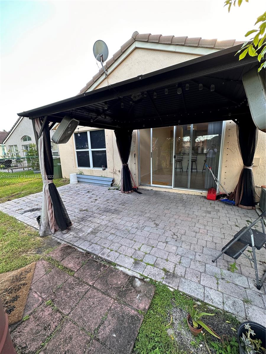 1041 Southeast 20th Road Homestead, FL 33035 - Photo 39 of 40 a front view of a house with garden