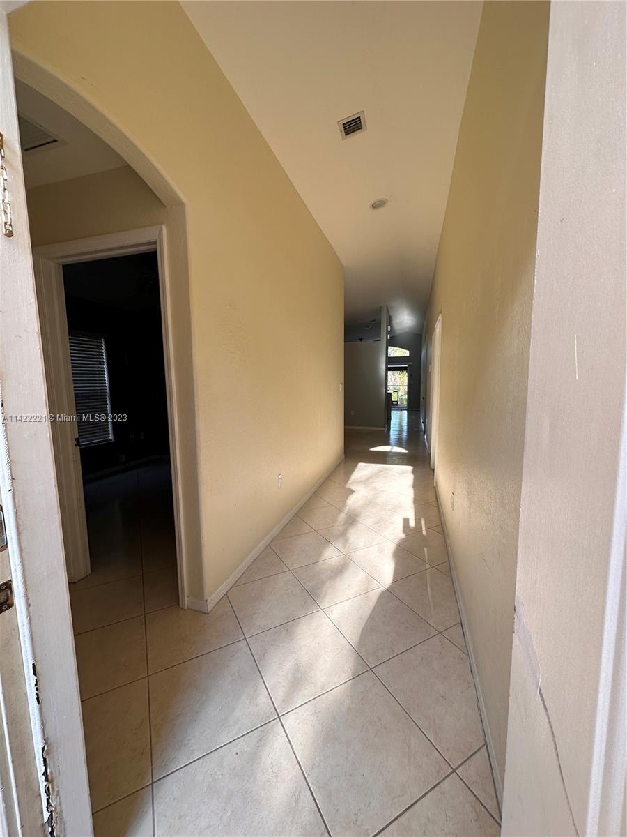 1041 Southeast 20th Road Homestead, FL 33035 - Photo 4 of 40 a view of a hallway to rooms