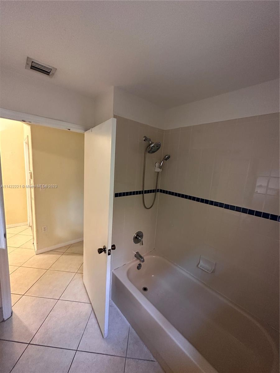 1041 Southeast 20th Road Homestead, FL 33035 - Photo 8 of 40 a bathroom with a bathtub and a shower