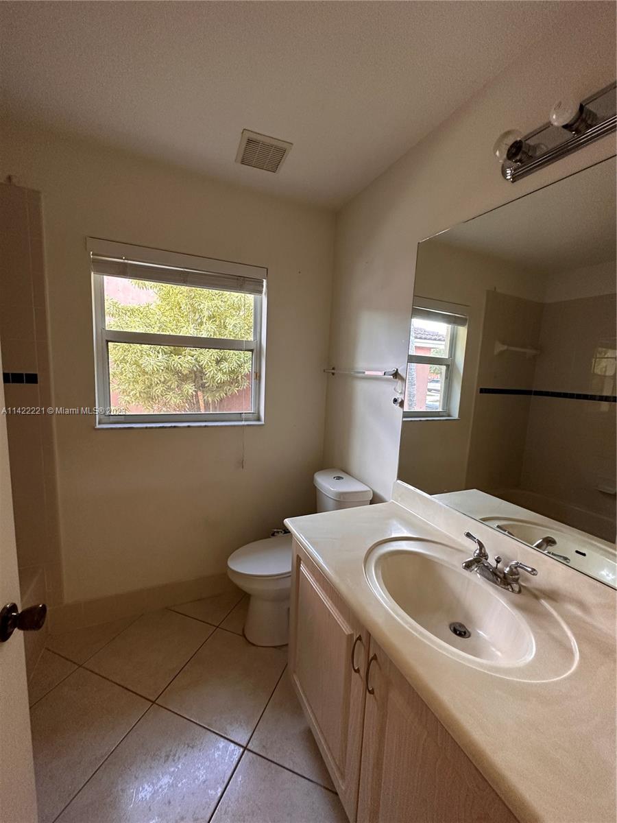 1041 Southeast 20th Road Homestead, FL 33035 - Photo 9 of 40 a bathroom with a sink toilet and mirror