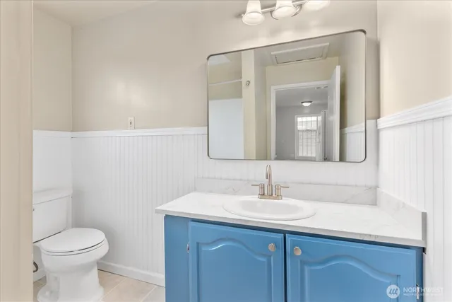 a white toilet sitting next to a shower