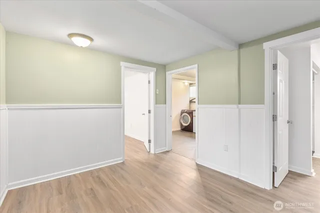 a view of a room with wooden floor and window