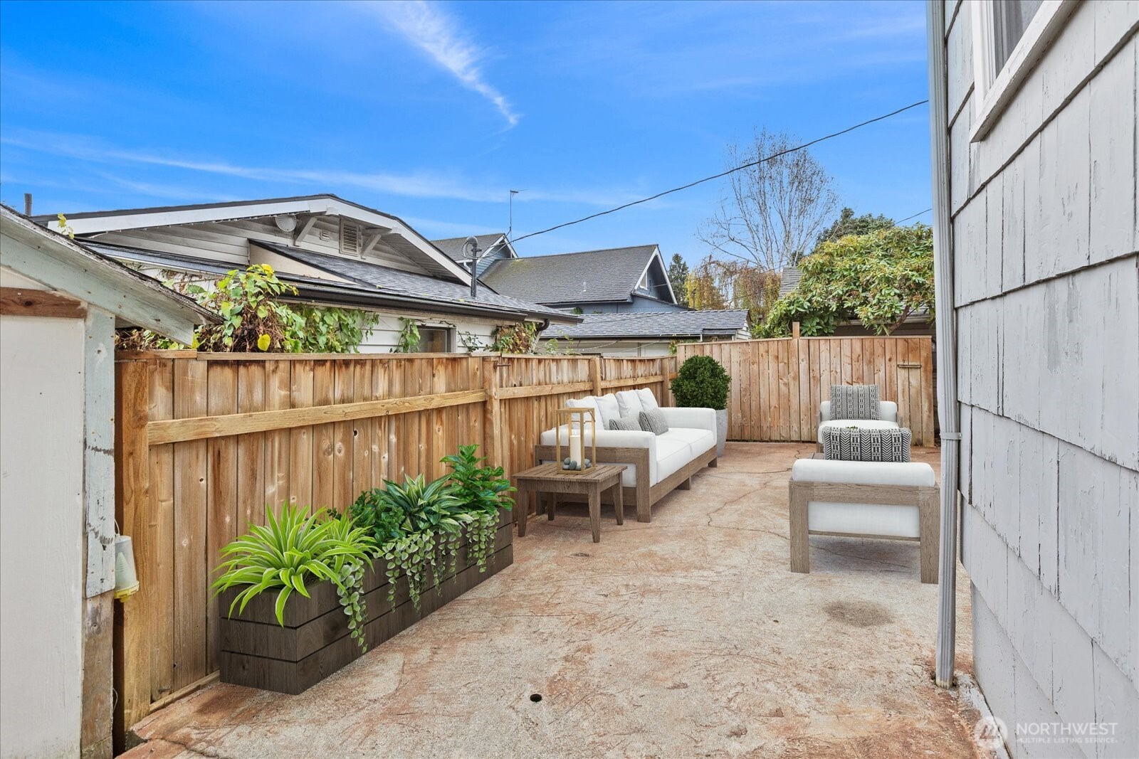 1016 Rockefeller Avenue Everett, WA 98201 - Photo 23 of 29 a view of a patio with table and chairs potted plants with wooden fence