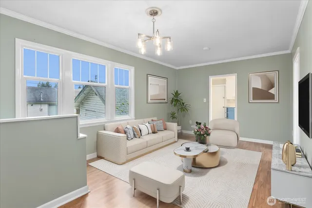 an empty room with wooden floor chandelier and windows