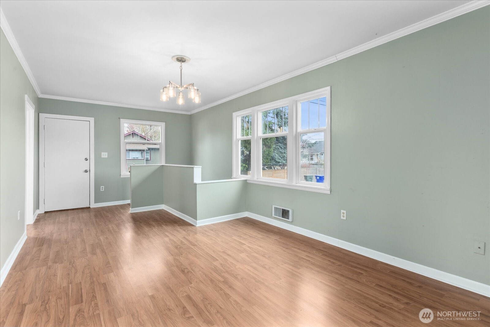 1016 Rockefeller Avenue Everett, WA 98201 - Photo 4 of 29 an empty room with wooden floor chandelier and windows