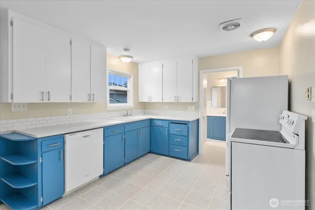 a kitchen with a stove top oven and cabinets