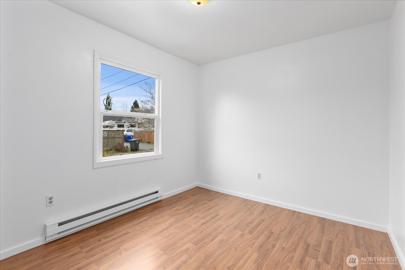 1016 Rockefeller Avenue Everett, WA 98201 - Photo 10 of 29 a view of an empty room with wooden floor and a window