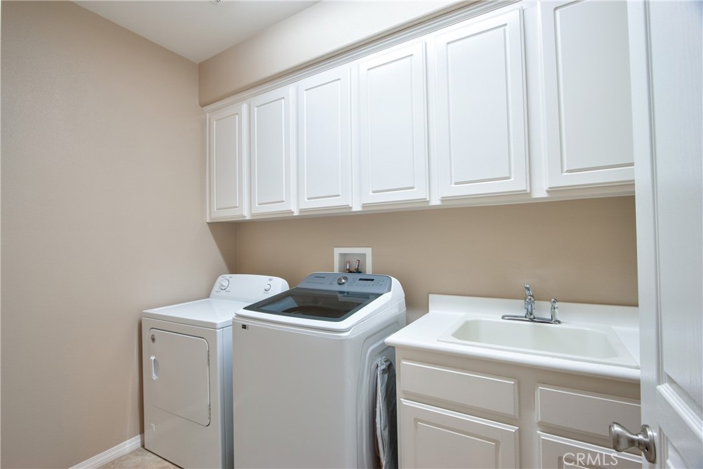 28483 Nautical Point Circle Menifee, CA 92585 - Photo 14 of 44 a utility room with dryer and washer
