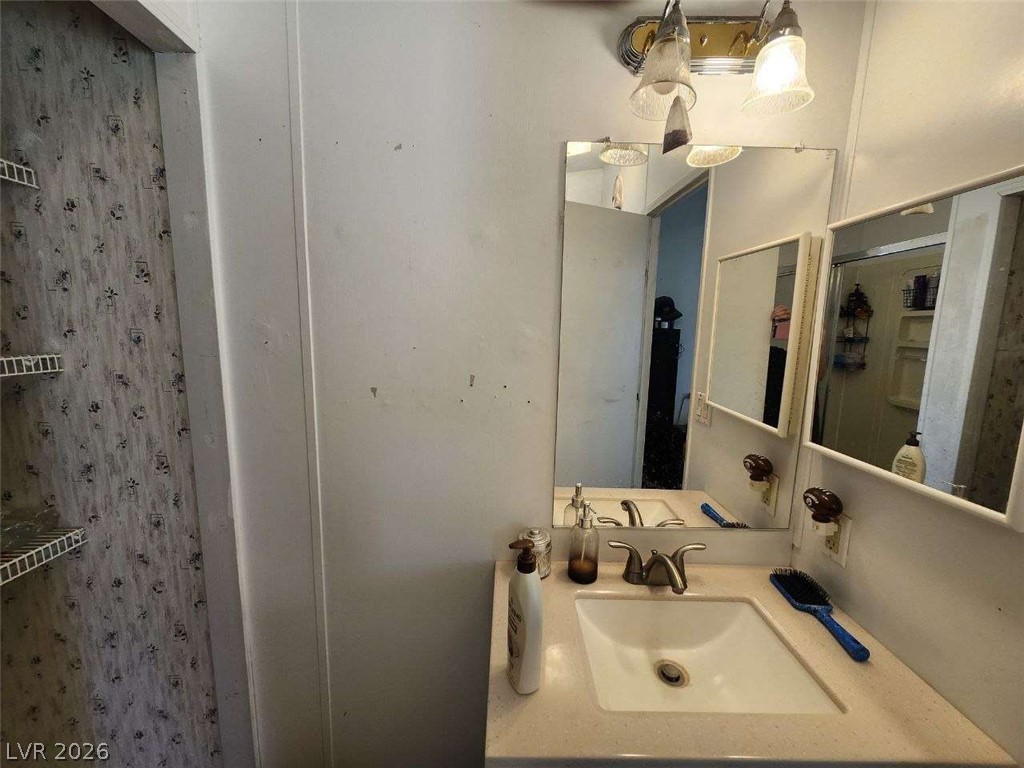 942 Holt Caliente, NV 89008 - Photo 17 of 22 A well-lit vanity with a broad mirror, offering practical storage adjacent to the sink.
