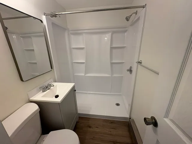 a bathroom with a toilet sink and shower