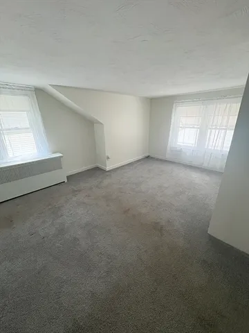 an empty room with a empty space and windows